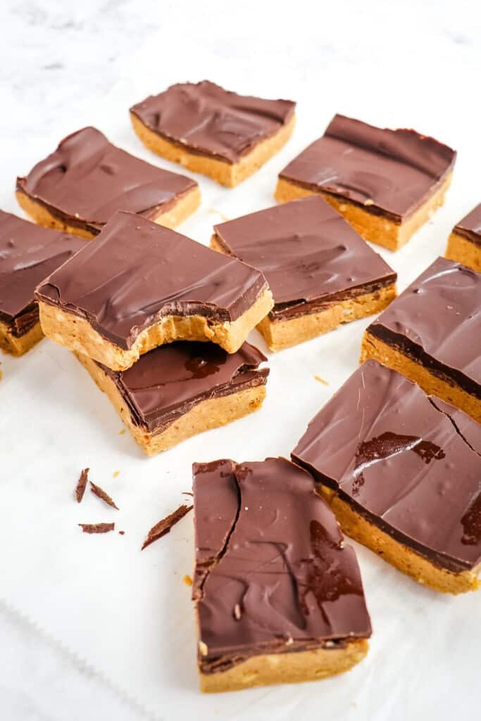 Homemade protein bars cut into squares on flat surface.