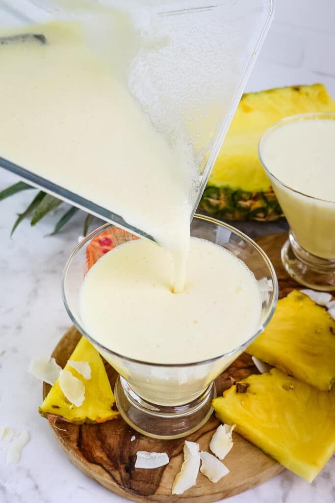 Malibu pina colada being poured into glass from blender.