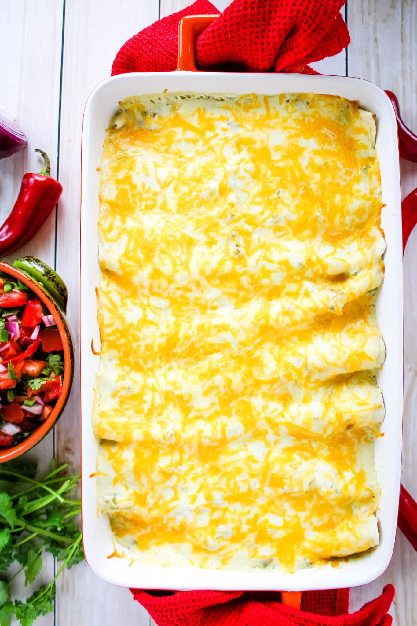 Baked enchiladas topped with melted cheese.