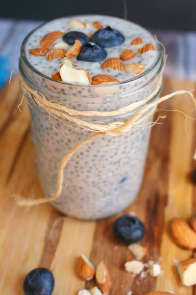 Blueberry chia pudding in mason jar, topped with fresh blueberries and chopped almonds.