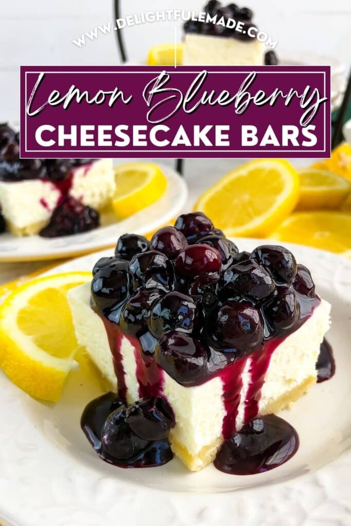 Square of lemon blueberry cheesecake, topped with blueberry topping and garnished with lemon.
