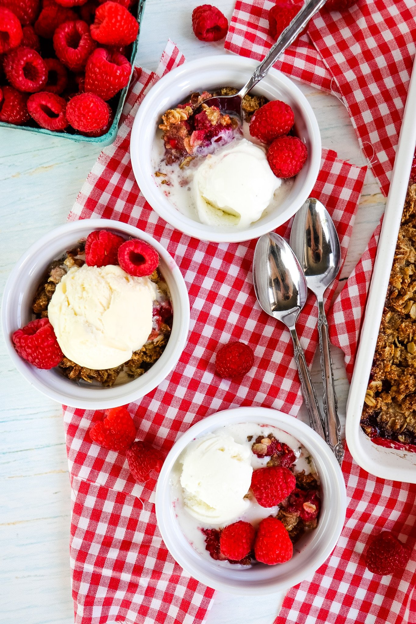 Three dishes of raspberry crumble.