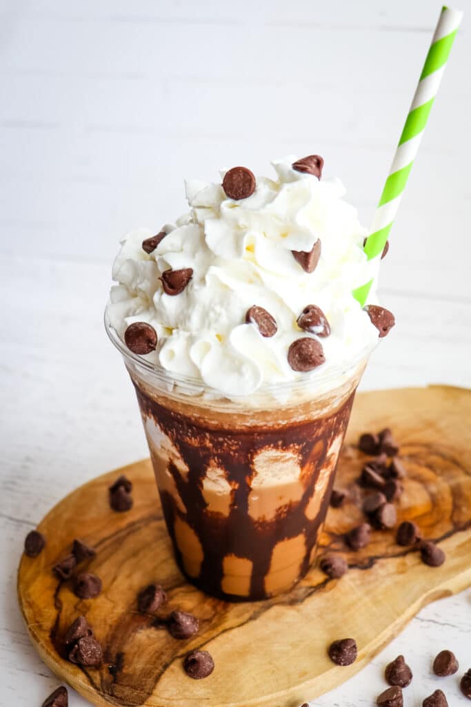 Starbucks mocha frappuccino topped with whipped cream and chocolate chips.