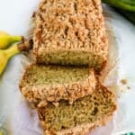 Zucchini banana bread loaf, with two slices on the side.