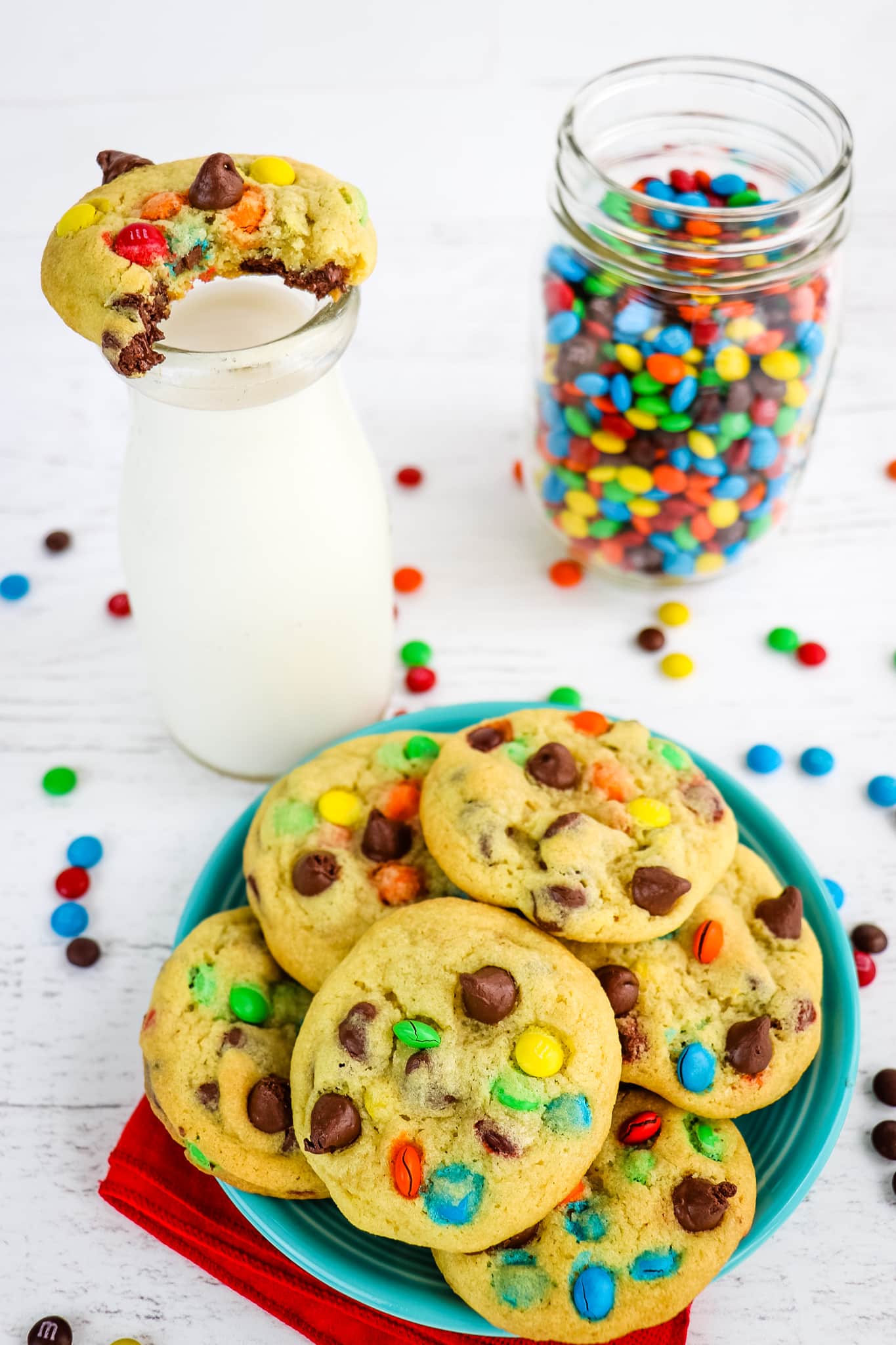 Chocolate chip pudding cookies with bite take out of cookie on milk glass