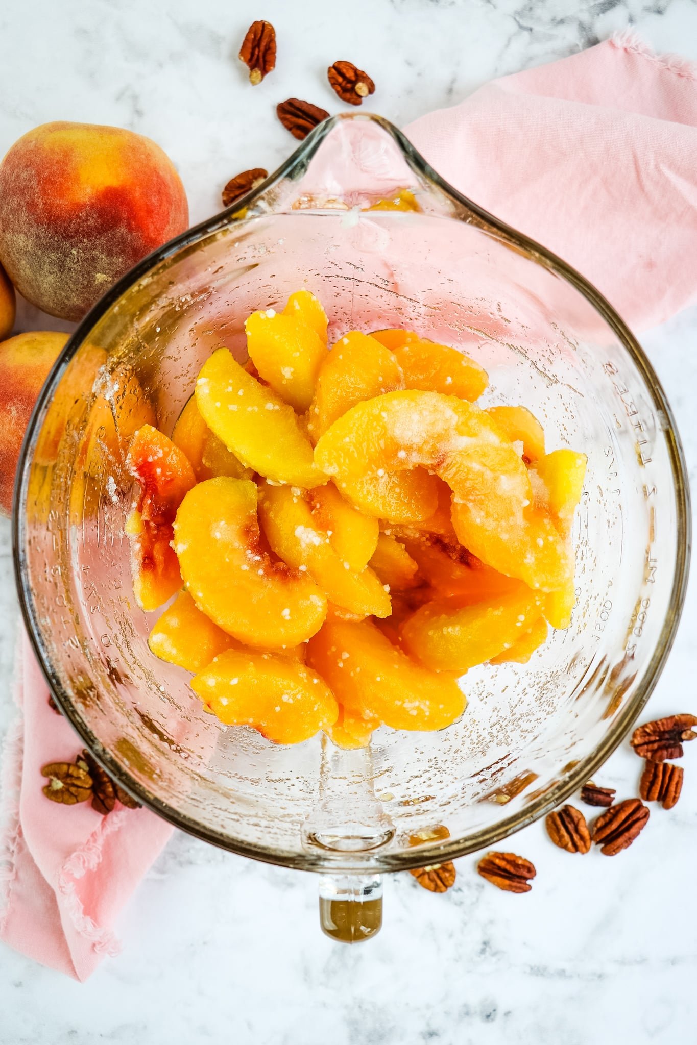 Sliced peaches in a bowl for healthy peach crisp recipe.