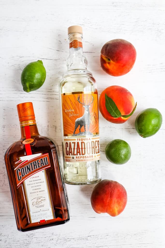 Ingredients needed to make a peach margarita.