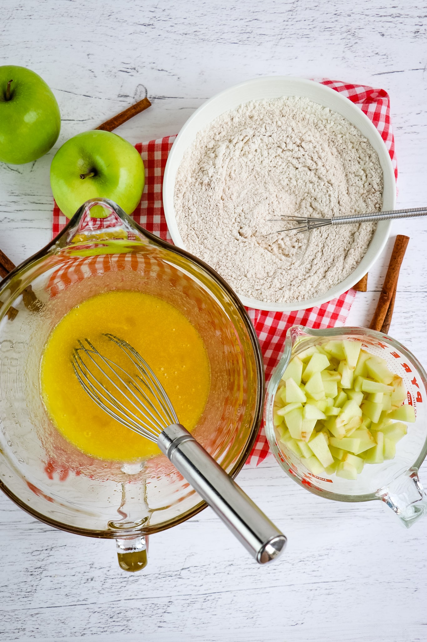 Wet ingredients, dry ingredients and chopped apples for cinnamon apple bread.