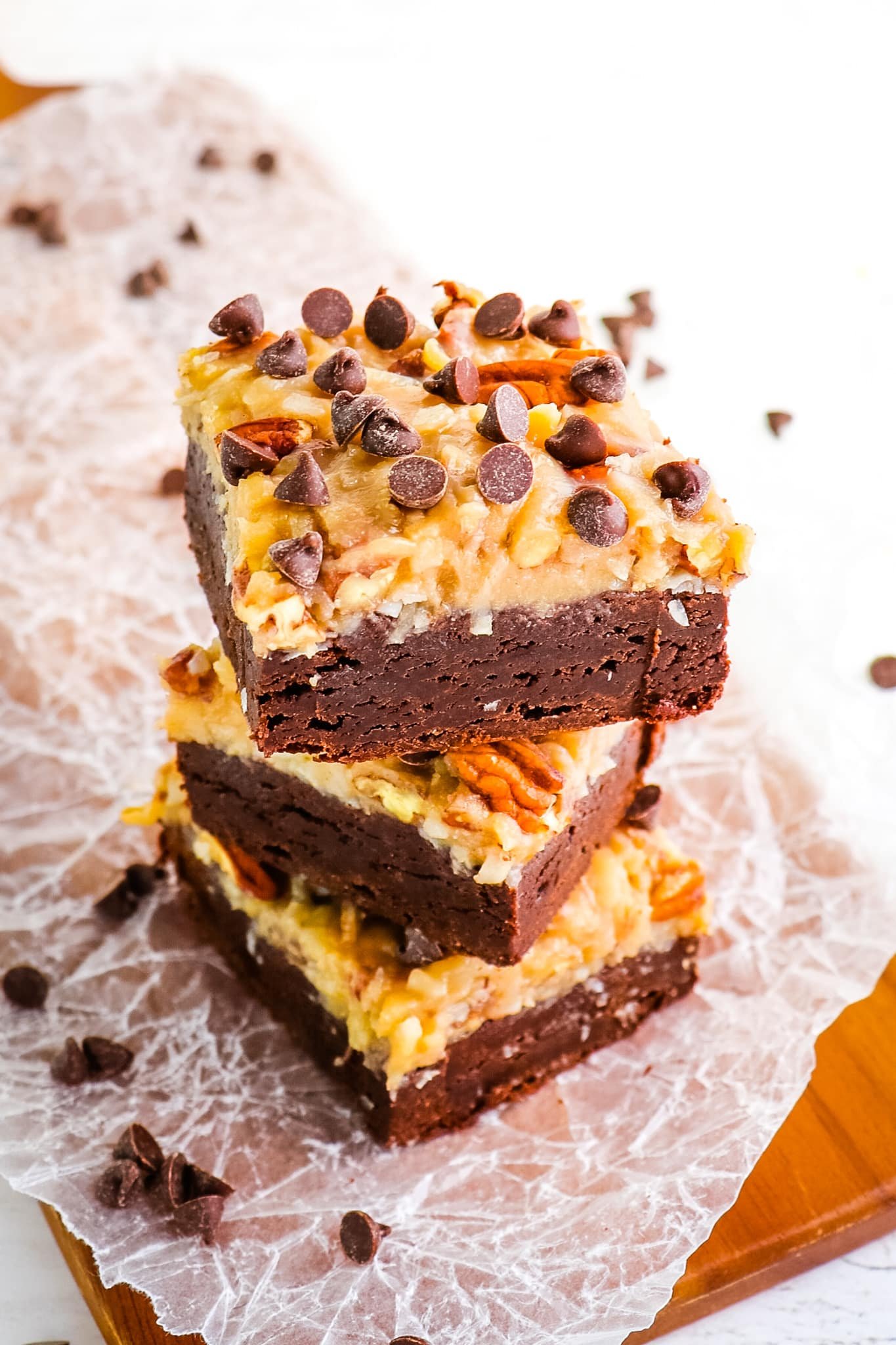 Stack of three German chocolate brownies topped with chocolate chips.