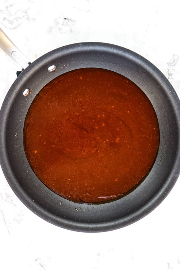 Honey sesame chicken sauce in skillet.