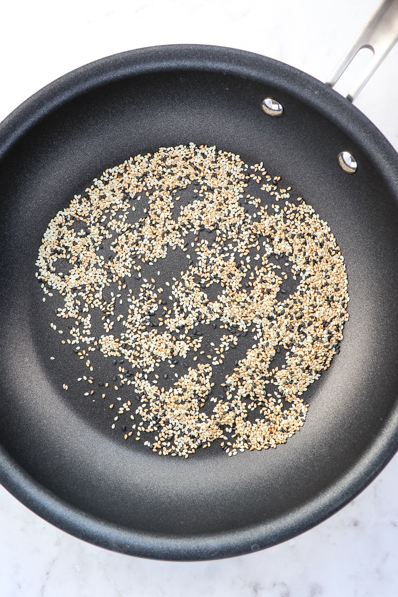 Toasted sesame seeds in skillet.