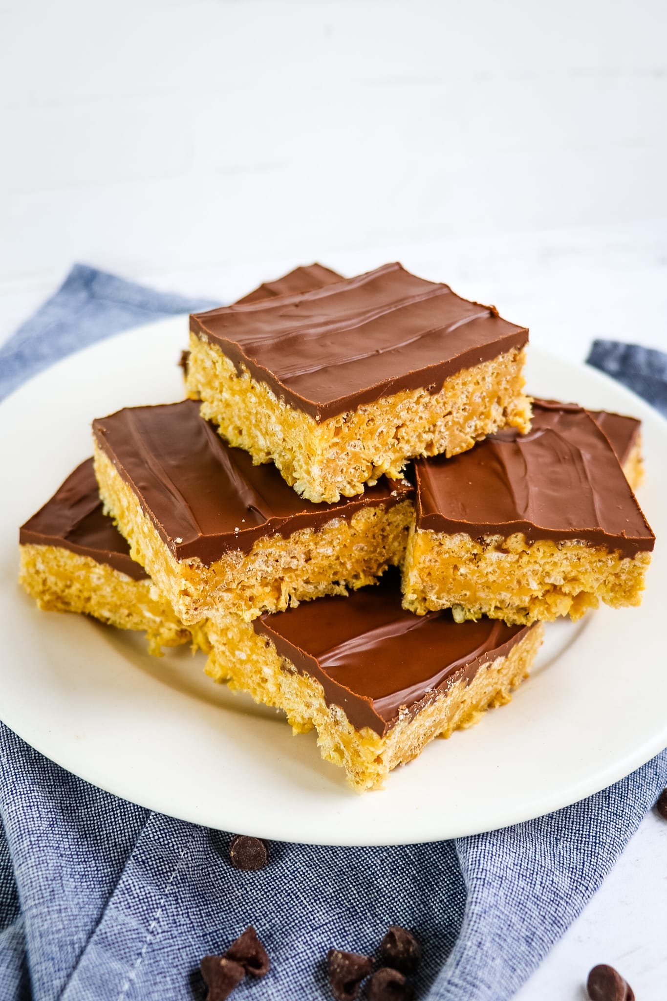 Chocolate peanut butter rice krispie treats, stacked on a plate.