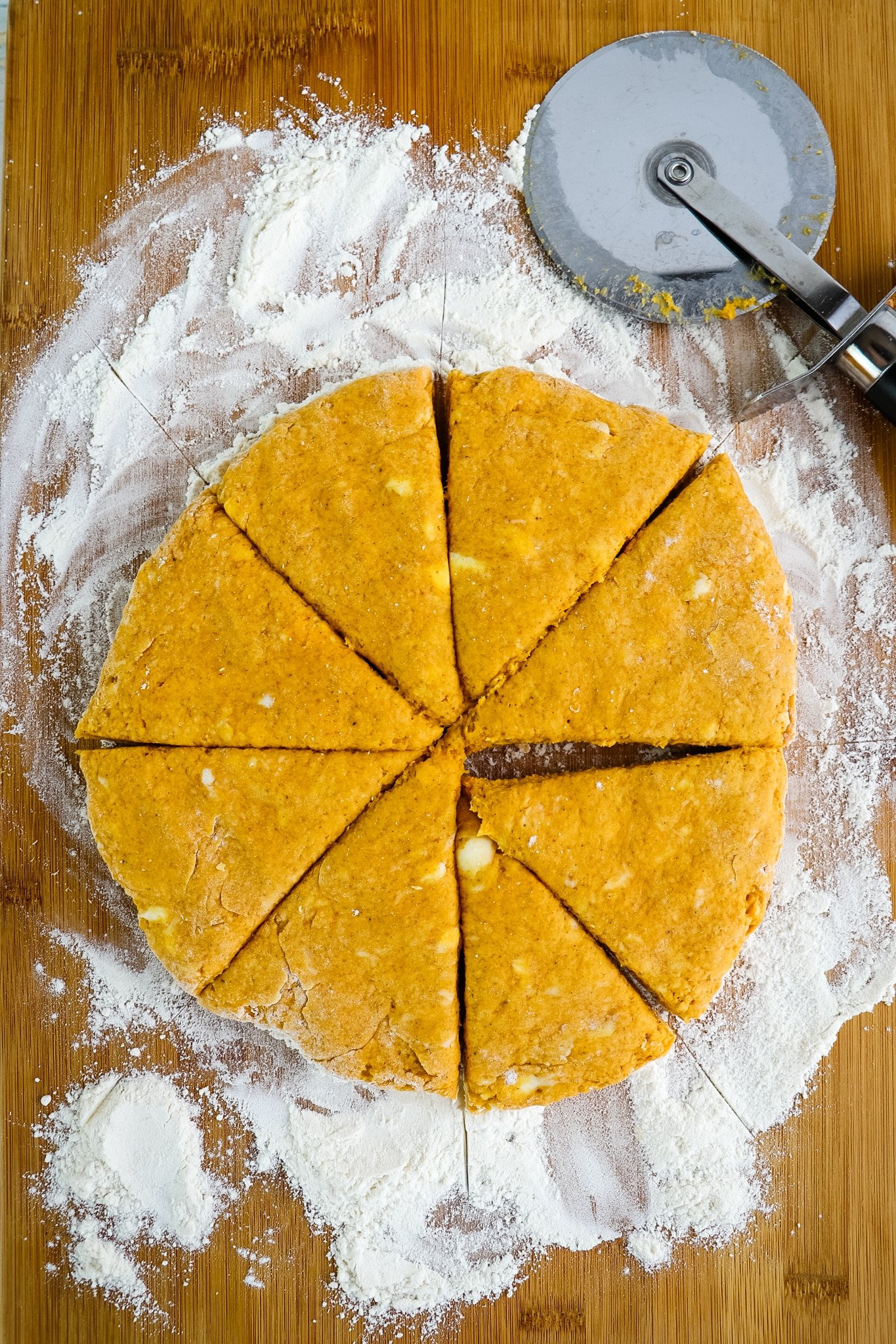 Dough cut into triangles for pumpkin scones.