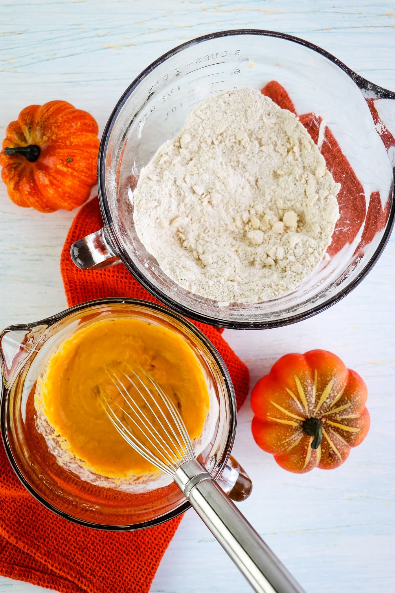 Dry ingredients and wet ingredients in bowls for pumpkin scones recipe.