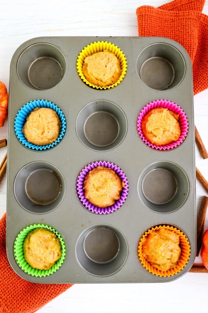Muffin batter in muffin tin for healthy pumpkin muffins.