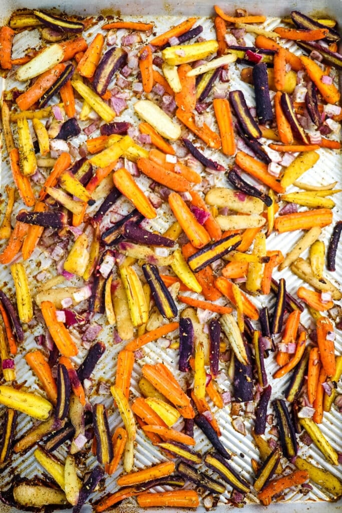 Roasted rainbow carrots on a sheet pan after coming out of the oven.