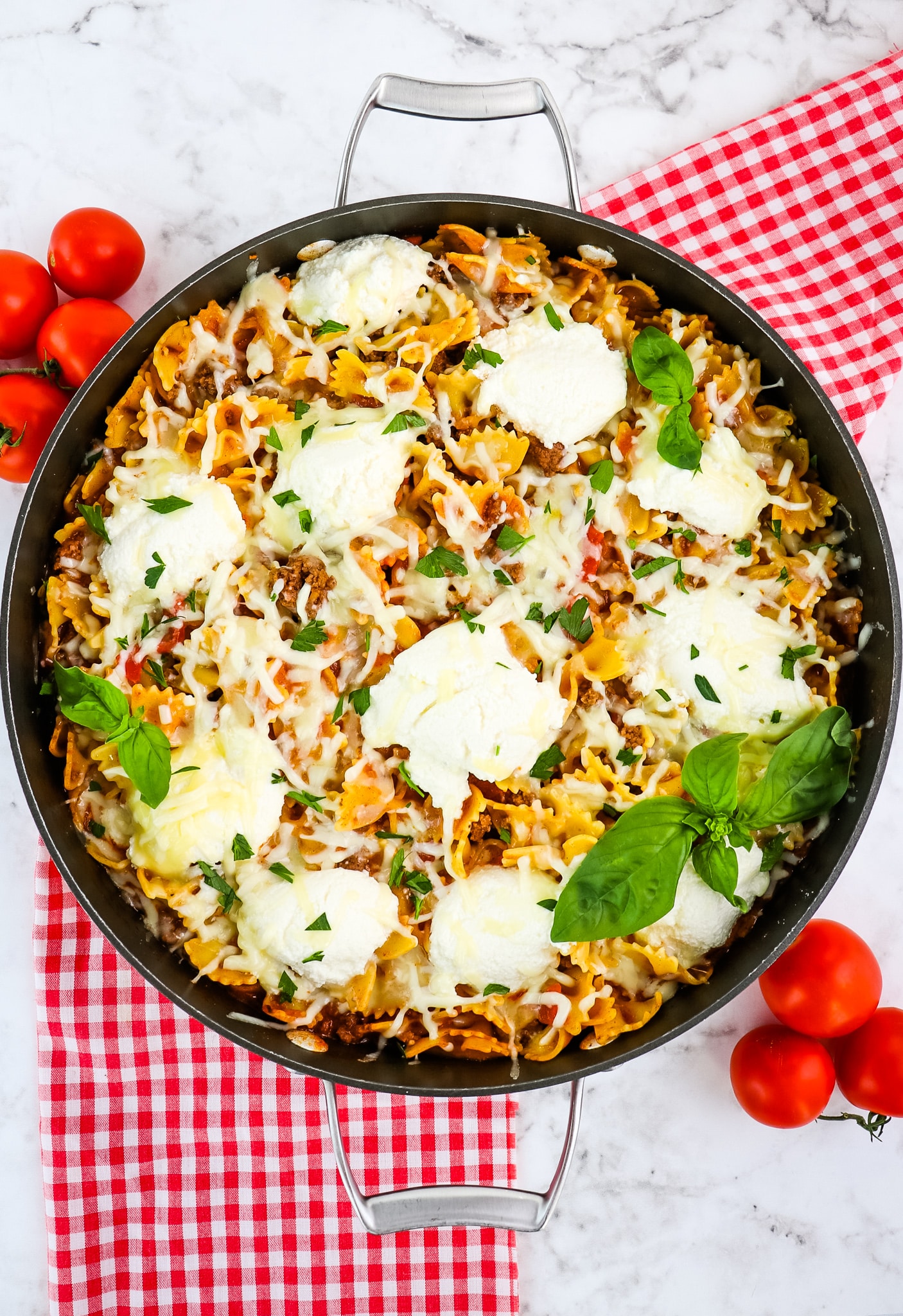 Skillet lasagna topped with fresh basil leaves.