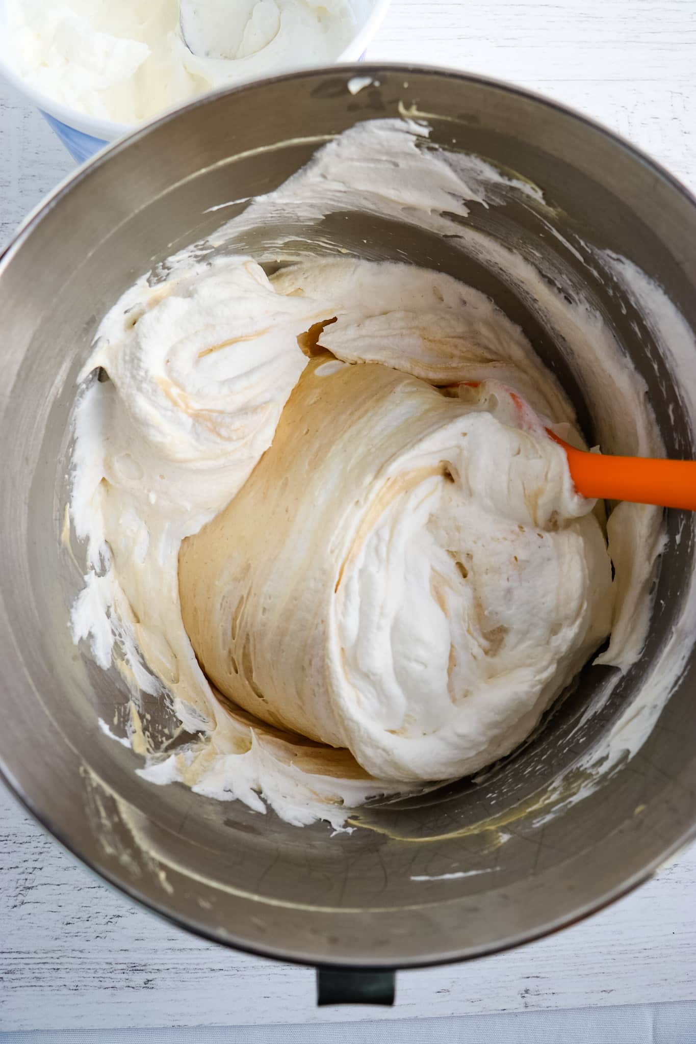 Alling cool whip to filling for peanut butter pie.