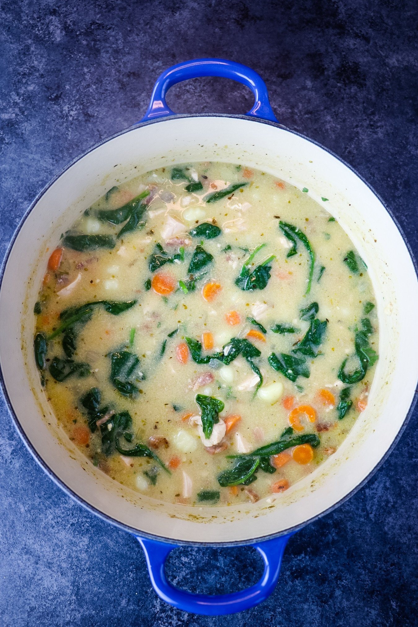 Pot of Olive garden chicken gnocchi soup, with spinach.