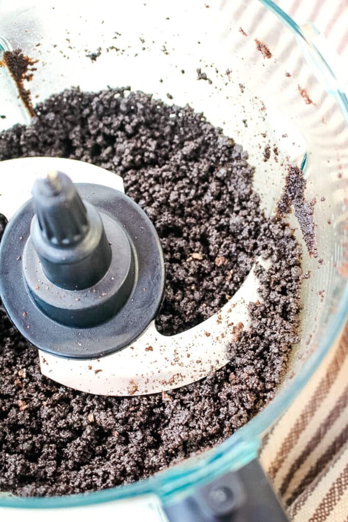 Oreo cookie crumbs in a food processor.