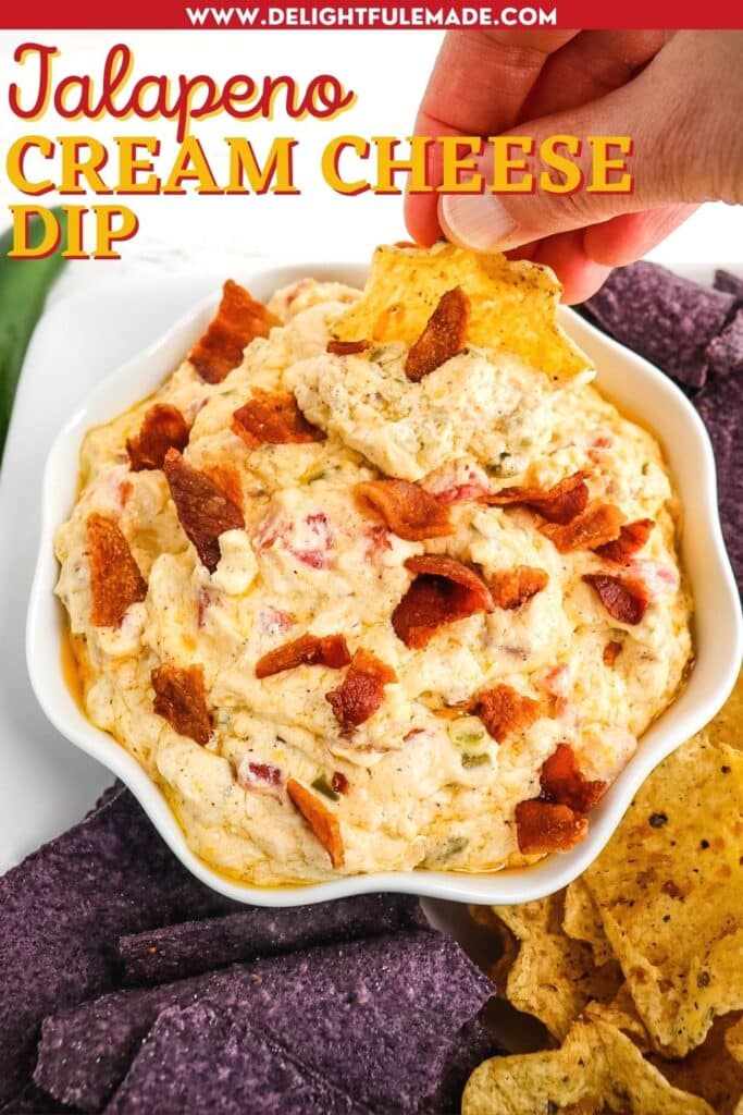 Jalapeno cream cheese dip topped with pieces of bacon and served alongside tortilla chips.