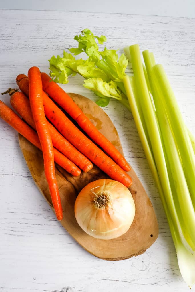 Carrots, celery and onion for making hearty chicken noodle soup.