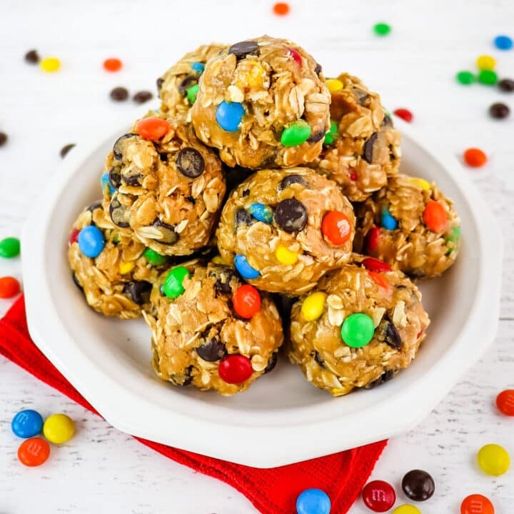White plate with stack of no bake oatmeal balls with M&M's.