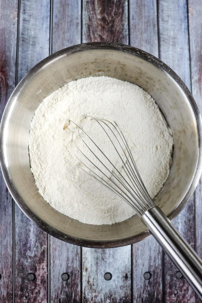 Dry ingredients in a mixing bowl for buttermilk chocolate cake.