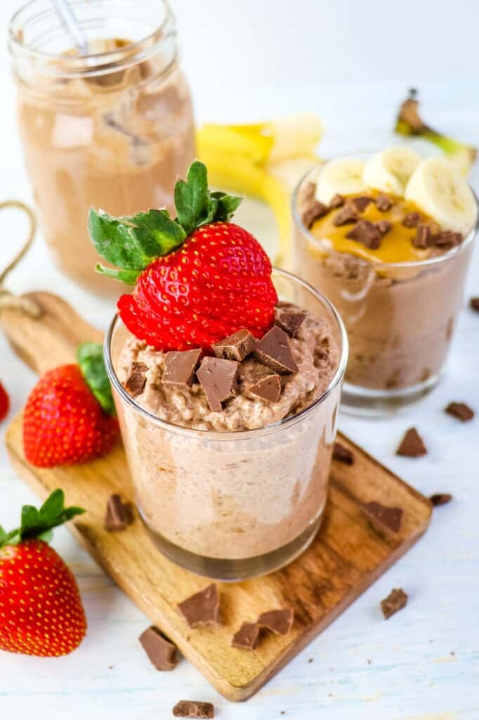 Sliced strawberry and chocolate chunks on top of chocolate chia pudding.