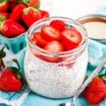 Strawberry shortcake overnight oats in a mason jar with spoon on the side.