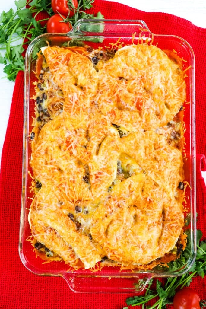 Baked beef enchilada casserole recipe in clear baking dish.