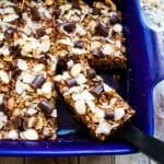 Chocolate baked oats cut into bars with one bar on a spatula ready to be served.