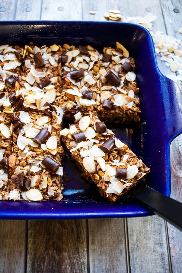 Chocolate baked oats cut into bars with one bar on a spatula ready to be served.