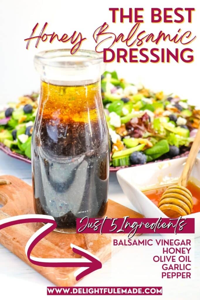 Honey balsamic dressing in a jar in front of a salad with honey on the side.