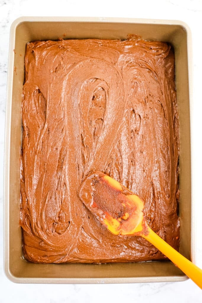 Brownie batter for lunch lady brownies spread into a 9 x 13" pan.