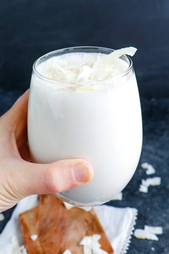 Coconut milk smoothie held in hand.