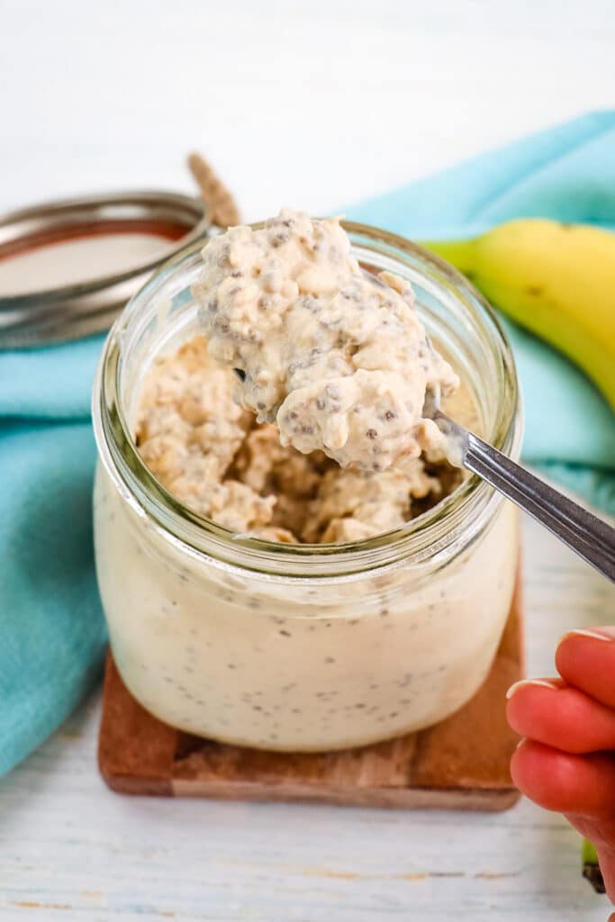 Peanut butter banana overnight oats after being refrigerated with spoon taking bite.
