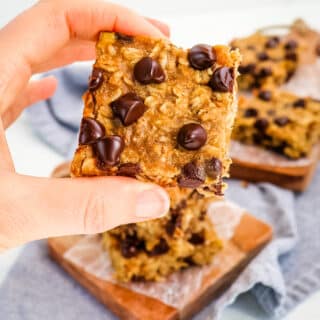 Peanut butter oatmeal bar with chocolate chips held in hand.