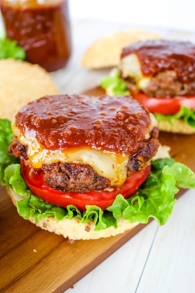 BBQ burgers topped with barbecue sauce.