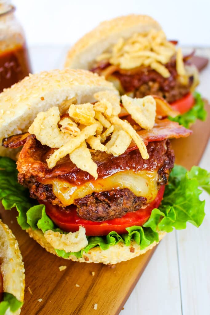 BBQ burgers topped with french fried onions, bacon, cheese and bbq sauce.