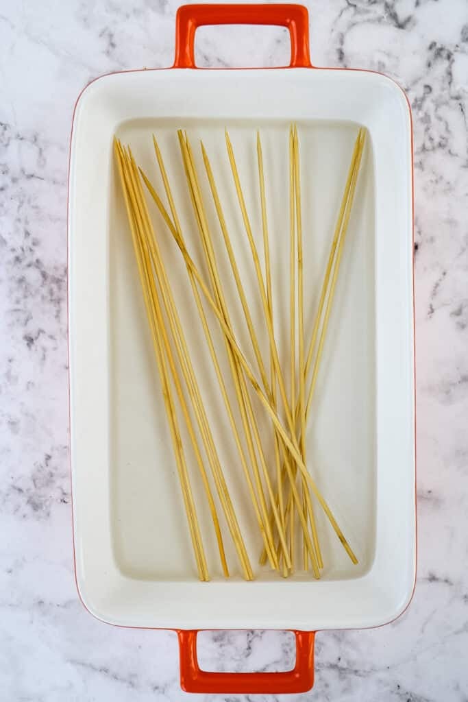 Wooden skewers soaking in water for making bbq chicken skewers.