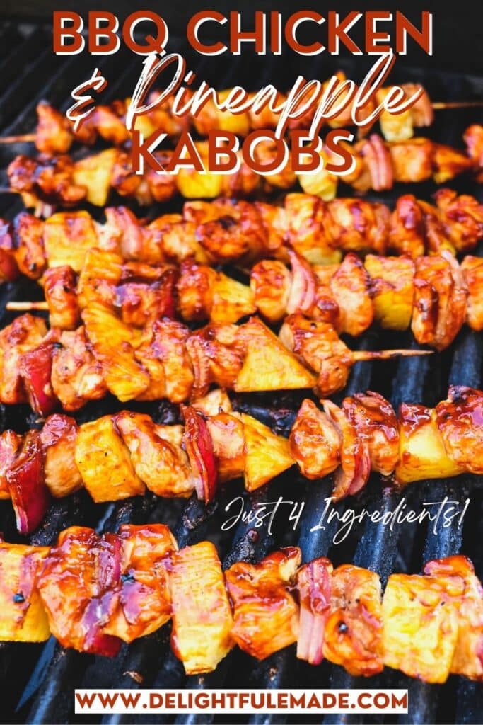 BBQ chicken kabobs with pineapple on the grill topped with barbecue sauce.