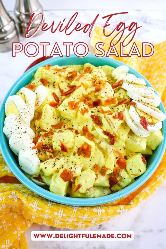 Deviled egg potato salad in a bowl, garnished with bacon bits, sliced eggs and fresh ground pepper.