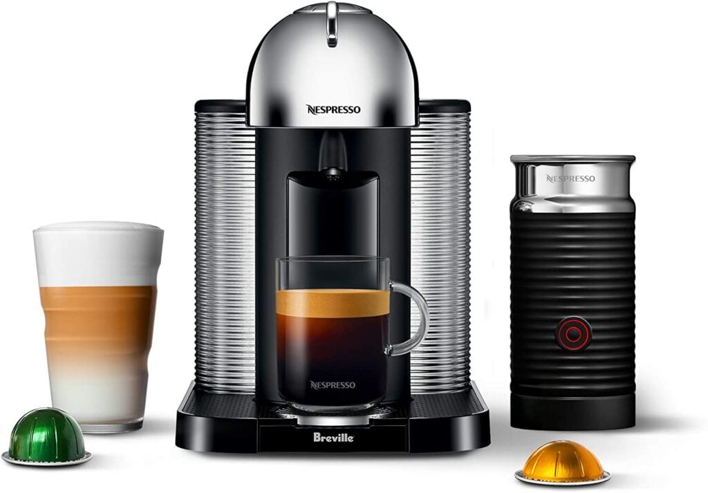 Photo of Nespresso machine with milk steamer and coffee pods.