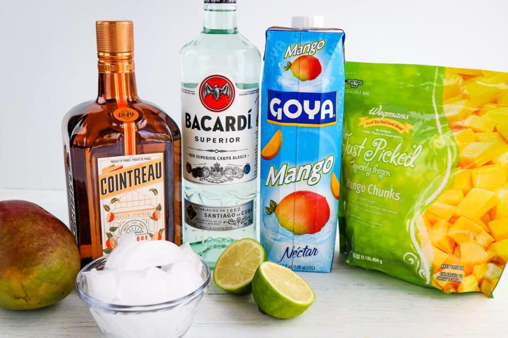 Ingredients needed to make a frozen mango daiquiri recipe.