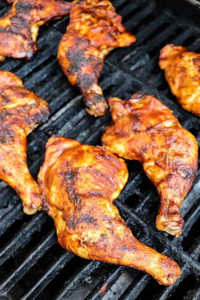 BBQ grilled leg quarters cooking on a gas grill.