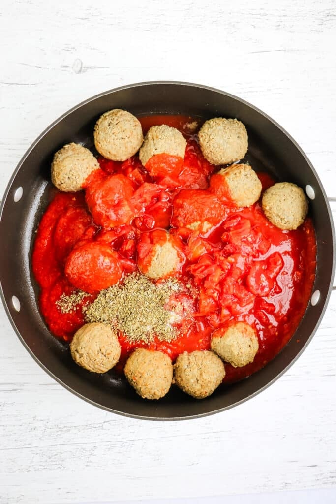 Meatballs, marinara and spices in a large skillet to make the meatball marinara recipe.