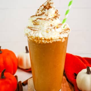 Pumpkin spice frappuccino recipe in a tall glass topped with whipped cream and cinnamon.