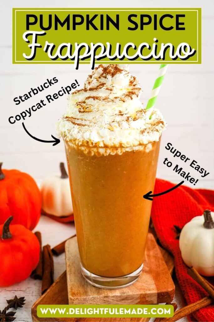 A starbucks pumpkin spice frappuccino topped with whipped cream and cinnamon with a green striped straw. Mini pumpkins in the background.