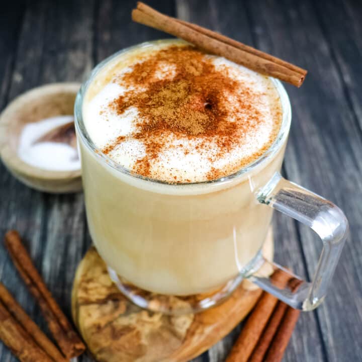 A cinnamon dolce latte topped with ground cinnamon and a cinnamon stick.